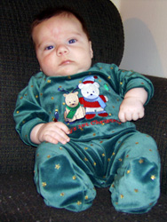 Kenji in a Christmas sleeper suit.