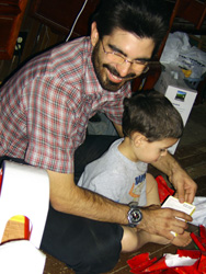 Dan helps Vincent unwrap a present