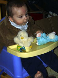 Kenji plays with spring chick and bunny toys.