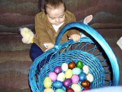 Kenji peers inside his Easter basket.