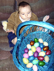 Kenji plays with his Easter basket.