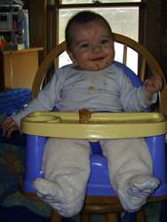 Kenji eats his first baby-safe cookie.