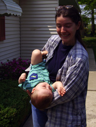 Samantha holds Kenji upside down.