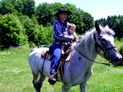 Grandma takes Kenji for a horse ride.