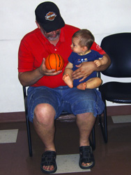 Karl and Kenji bounce a basket ball.