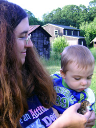 Brandy shows Kenji a baby chick.