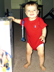 Kenji stands up next to a box.