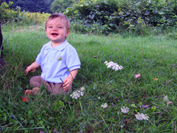 Kenji sits up on the lawn.